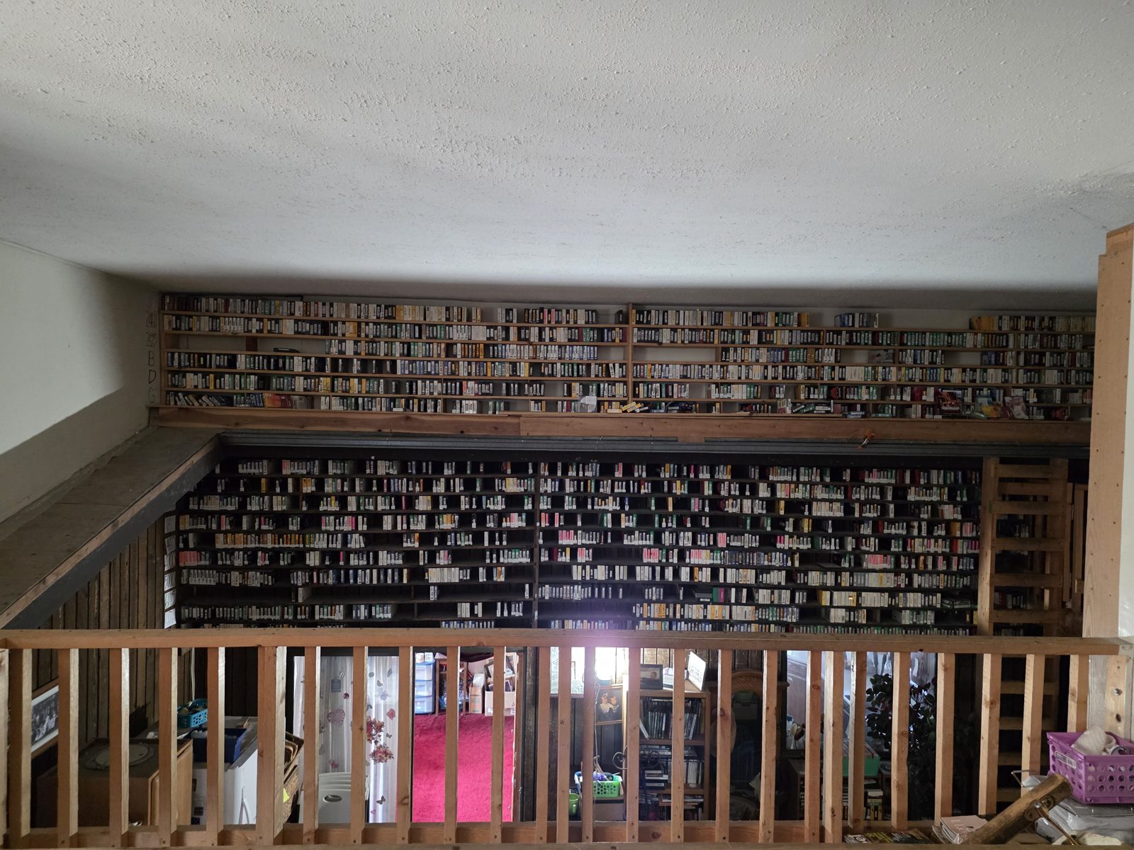 Two floors of shelves filled floor to ceiling with VHS tapes